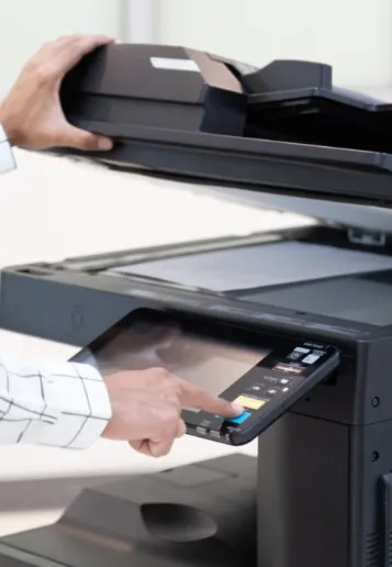 Businessman using the control panel of an office photocopier