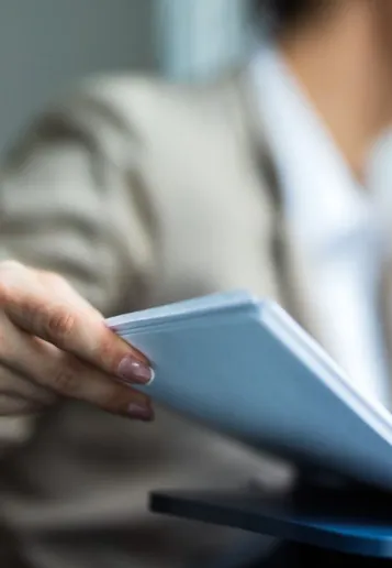 Businesswoman feeding documents into a fax machine
