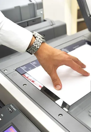 Hand operating an office copier