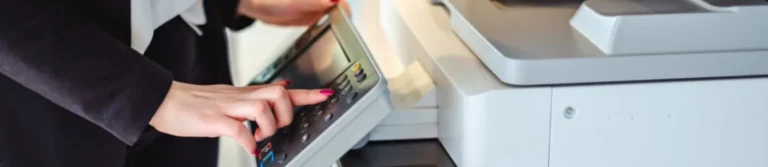 Woman pressing a button on an office copier