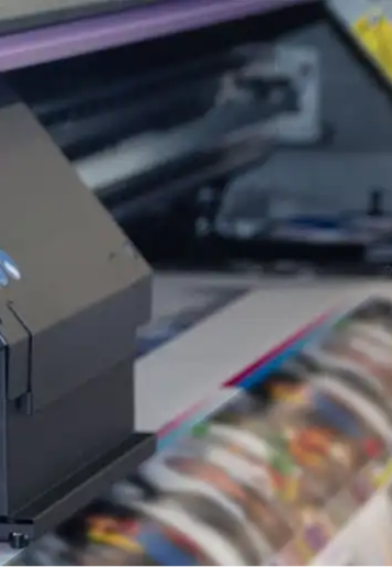 Close-up of a production printer outputting full-colour prints
