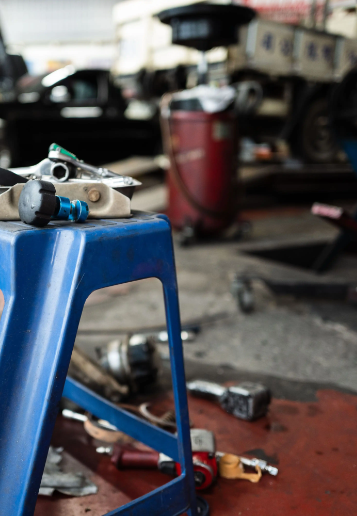 Mechanic tools laid out on a stand in an automotive workshop